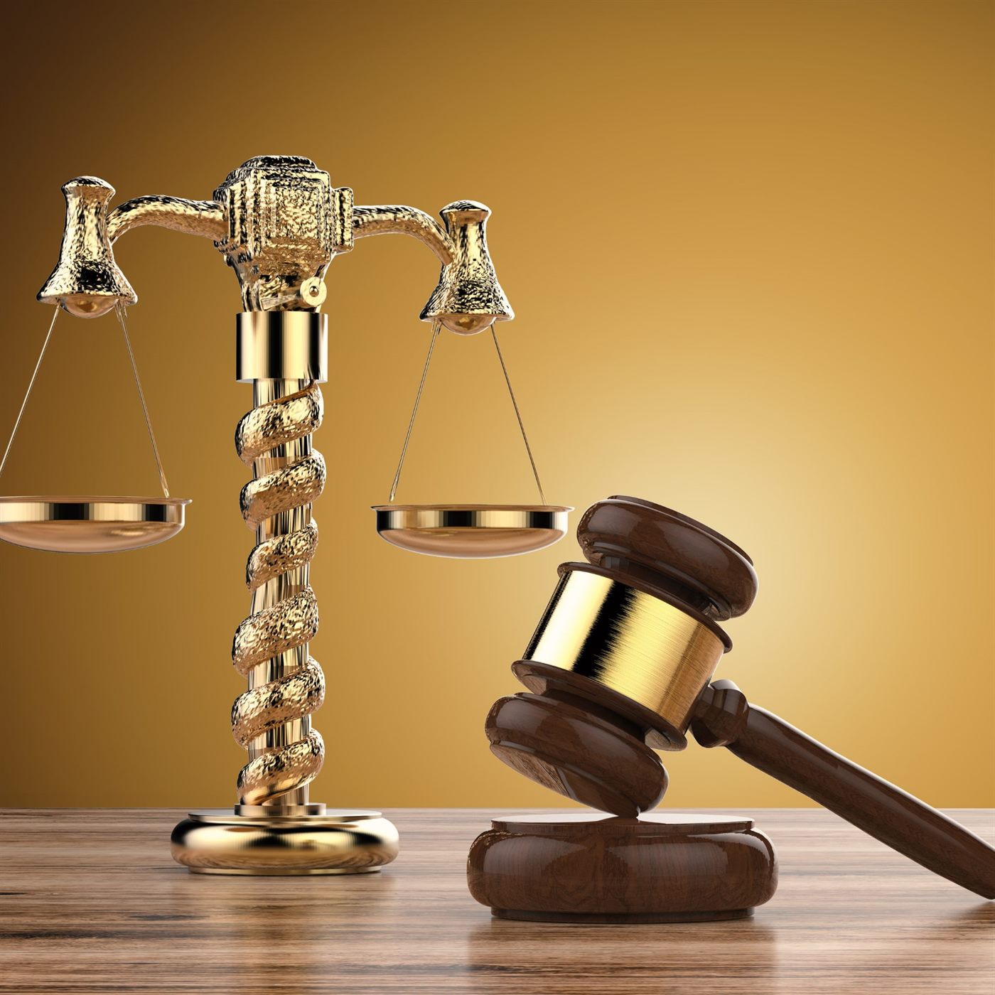 Golden scales of justice beside a wooden gavel